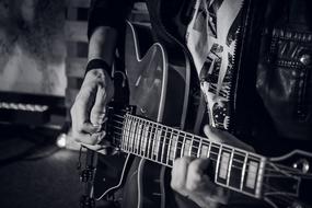 electric guitar in male hands, black and white
