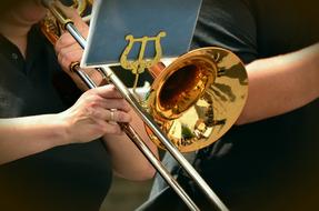 woman is playing trumpet in orchestra