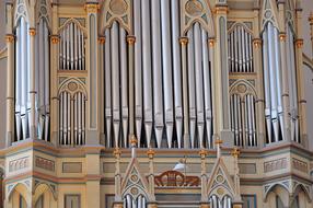 photo of a church organ with white pipes