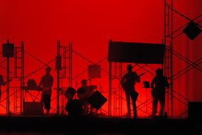 silhouette of a music band on the scene
