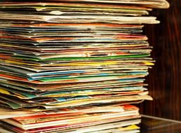 stack of vinyl records with weathered covers