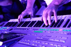 Photo of male hands on Keyboard of Musical instrument