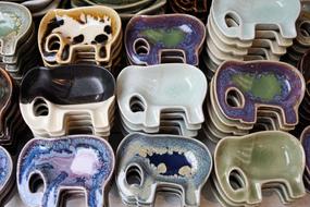 Colorful and beautiful, patterned, shiny plates in the shape of the elephants