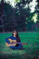 girl with a guitar in the woods