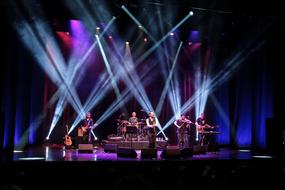 a group of musicians under the spotlights on stage