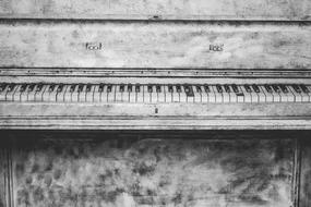 black and white photo of an old piano