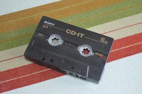 Old, black and brown "Sony" CD IT cassette, at the background with colorful lines