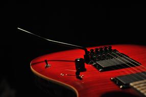 red electric guitar in black background