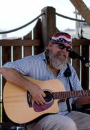 a man with a beard plays the guitar