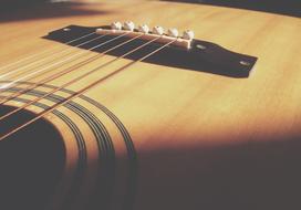 thin strings of a wooden guitar