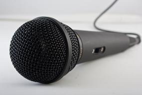 black microphone close up on blurred background