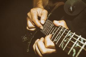 male hands playing guitar