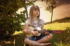 Person Child playing on guitar