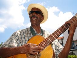 guitarist in sunglasses on cube