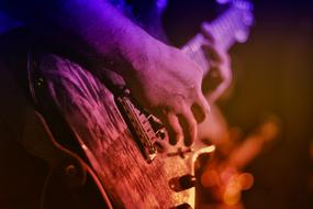 electric guitar in the hands of a musician at a concert