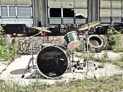 set of percussion instruments outdoor at grunge wall