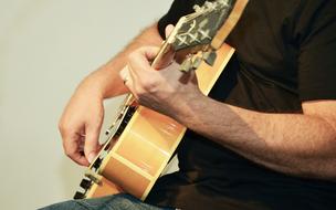 musician playing guitar at a concert