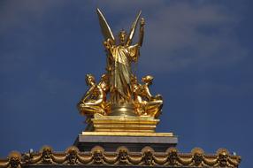 golden sculpture on the roof of the opera in paris