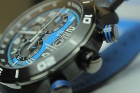 Black and blue wristwatch with numbers around