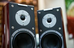 two black and grey music speakers on the table