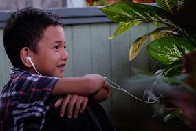 boy listens to music through headphones