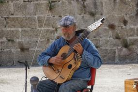 Guitarist, senior man plays guitar outdoor