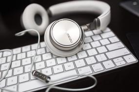 White Headphones on computer Keyboard