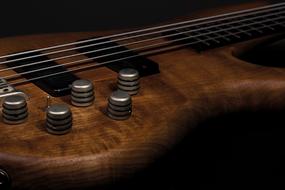 macro photo of a brown wooden guitar
