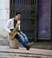 saxophonist playing a melody in the street