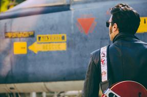 Back View of Man with Guitar at airplane