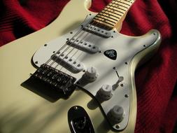white electric guitar on a red plaid