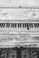 monochrome photo of an old classical piano