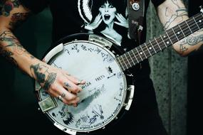 guy with tattoos with musical instrument
