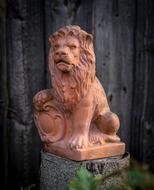statue made of red clay in the form of a lion