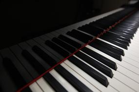 keys are reflected on the surface of the piano cover