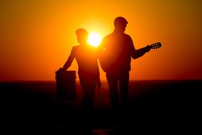 musicians against the backdrop of the setting sun