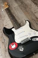 black and white musical guitar on the floor