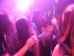 crowd of people is dancing in a nightclub