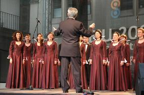 photo of the conductor and orchestra on stage