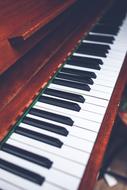 Keyboard on a wooden piano close up