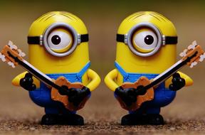 figurines of two minions with guitars