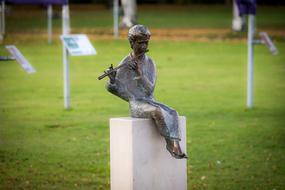 bronze sculpture of flute player