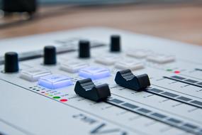 Console of Mixer with colorful buttons and switchers in Radio studio