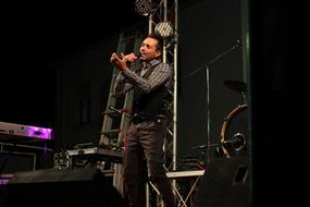 singer on stage among musical instruments