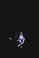 cool girl plays guitar on stage at darkness