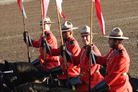 four Mounted Policemen with flags