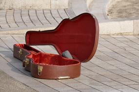 Wooden guitar Case on the pavement on the street