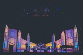 Band on the concert stage with colorful lights