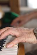 man hands playing piano