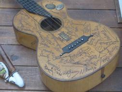 autographs on a wooden guitar